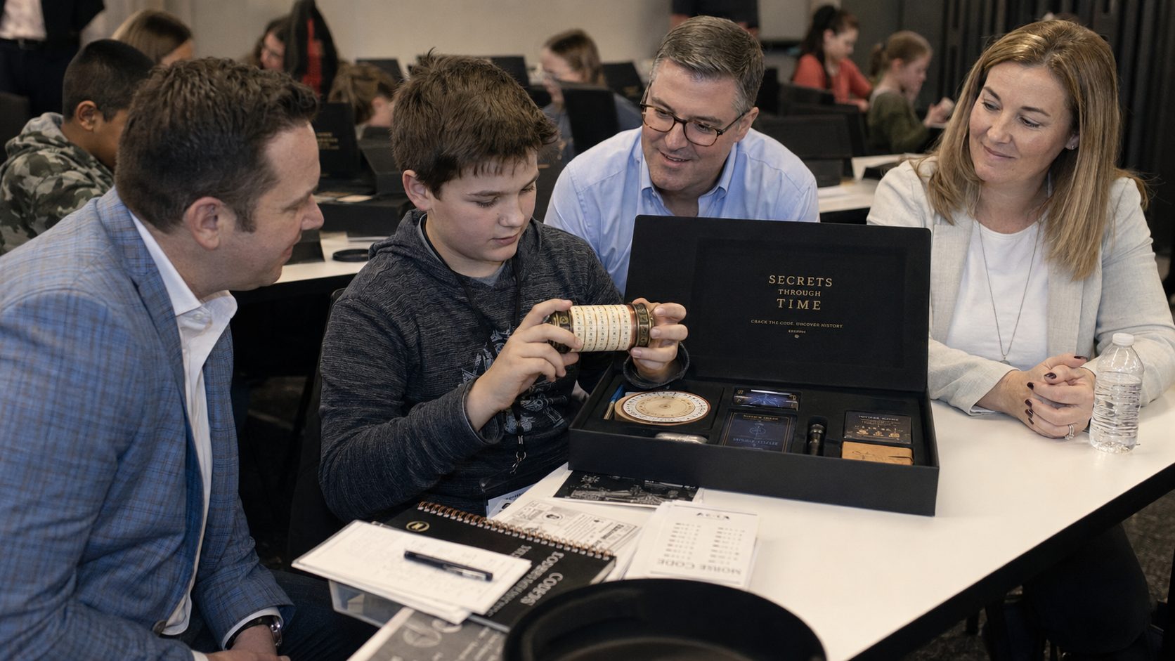 A child and adults opening the cryptex together during Inspiring Minds