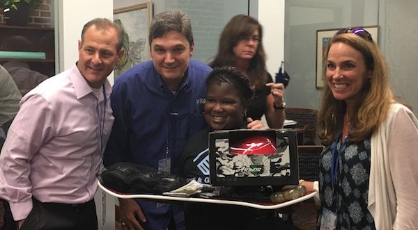 Leaders presenting something they built to a child