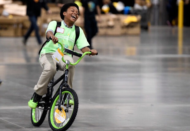 DaVita's annual partner meeting with bike build and giveaway to kids